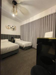 a hotel room with two beds and a television at قرية الراحه مرسى زايد in Al Burj +23 photos