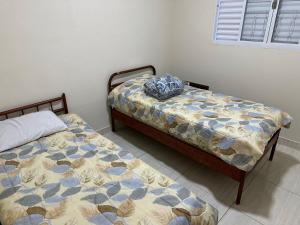 two beds sitting next to each other in a bedroom at Mar Azul in Espirito Santo Do Pinhal