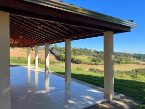 a pavilion with a view of a field at Mar Azul in Espirito Santo Do Pinhal