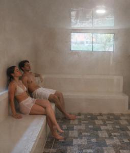a man and a woman sitting in a bath tub at Hotel Campestre Rocas Del Paraíso in Machetá