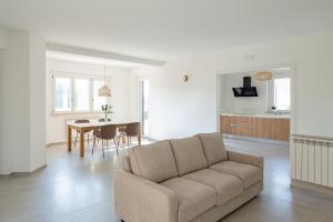 a living room and kitchen with a couch and a table at Villa Novelli - YourPlace Abruzzo in Fossacesia