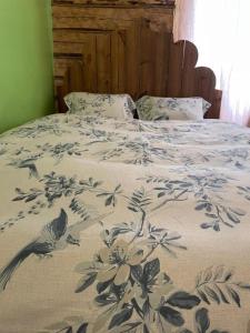 a bed with a blue and white comforter on it at Skansen in Vilnius