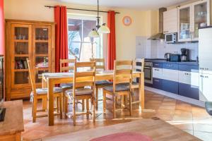 a kitchen with a dining room table and chairs at Ferienhaus Sandra in Wohlenberg