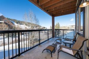 a balcony with benches and a view of the snow at Fraser Crossing 3302 in Winter Park