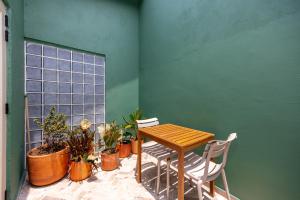 a table and chairs in a room with plants at Medellinn The Blooming Hotel in Medellín