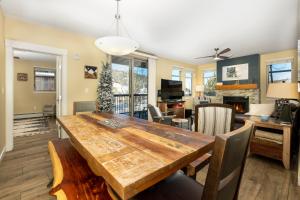 a dining room and living room with a wooden table at Fraser Crossing 3302 in Winter Park
