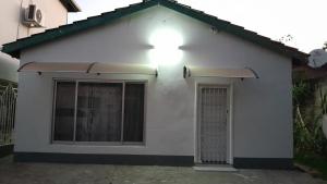 a white house with a light on top of it at Acacia House in Lusaka