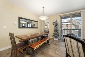 a dining room with a wooden table and a christmas tree at Fraser Crossing 3302 in Winter Park +23 photos
