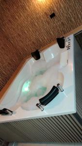 a bath tub with a black bottle in it at Hotel Torre Primavera in Medellín +86 photos