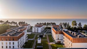 an aerial view of buildings and the ocean at Casella Apartment E34 Let's Sea Baltic Park in Gąski