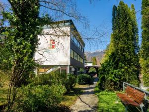 a building with a bench in front of it at Rax-Basecamp 24 in Reichenau