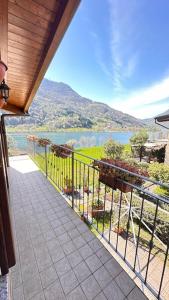 a balcony with a view of a river and mountains at Casa Candiotty Lake & Mountain in Endine Gaiano