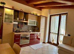 a kitchen with a sink and a stove top oven at Casa Candiotty Lake & Mountain in Endine Gaiano