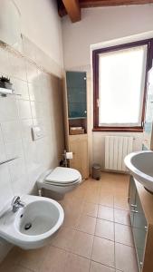 a bathroom with a white toilet and a sink at Casa Candiotty Lake & Mountain in Endine Gaiano +36 photos