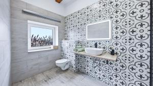 a bathroom with a toilet and a sink and a mirror at Penzion Pod Vinicemi in Litoměřice