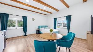 a room with a table and chairs and a bed at Penzion Pod Vinicemi in Litoměřice +80 photos