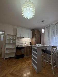 a kitchen with a table and a counter top at City Vibes in Subotica