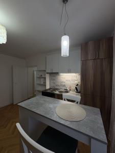 a kitchen with a island in the middle of a room at City Vibes in Subotica