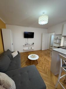 a living room with a couch and a table at City Vibes in Subotica