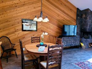 a dining room with a table and a fireplace at 3 Quelah Condo in Sunriver