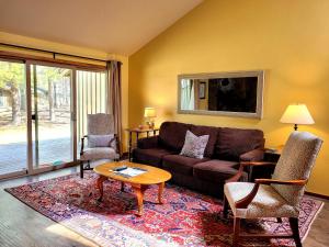 a living room with a couch and a table and chairs at 3 Quelah Condo in Sunriver
