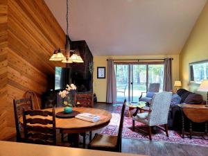 a living room with a table and a couch at 3 Quelah Condo in Sunriver