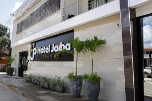a store with a sign on the side of a building at Hotel Jaiba Premium in Terra Fôfa +6 photos