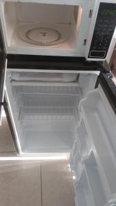 an empty refrigerator with its door open with its door openktopktopktopktopktop at APM Inn & Suite in Jacksonville