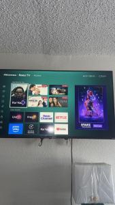 a monitor on a wall with several different videos at APM Inn & Suite in Jacksonville +16 photos