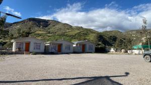 a row of houses in front of a mountain at Cabañas Wiñaypacha Putre in Putre