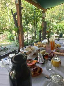 a table with food and drinks on top of it at Pousada Oliveira Ramos in Lumiar