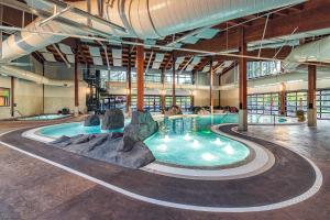 a swimming pool in a large building with a water slide at 32 Meadow House in Sunriver