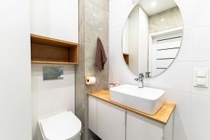 a bathroom with a sink and a mirror at Apartament Pirat in Ostróda +13 photos