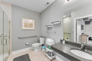 a bathroom with a sink and a toilet and a mirror at 8609 Landis Ave, Condo 201 in Sea Isle City +32 photos