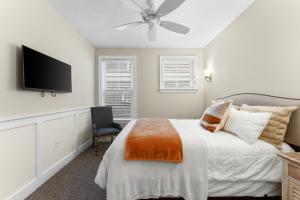 a bedroom with a bed and a flat screen tv at 8609 Landis Ave, Condo 201 in Sea Isle City