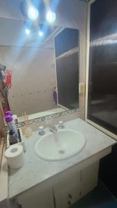 a bathroom with a sink and a large mirror at Quimelco casa de campo in La Granja +12 photos