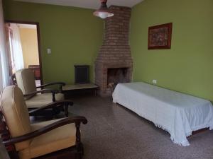 a bedroom with a bed and a fireplace at Quimelco casa de campo in La Granja