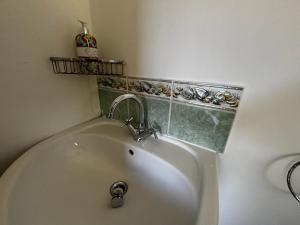 a bathroom with a bath tub with a sink at Tranquil Hideaway with Hot Tub and Pool Table in Cardiff +11 photos