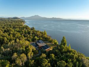 an aerial view of a house on a island in the water at Cascadas Hotel in Puerto Octay