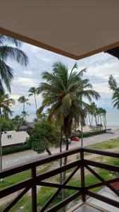 a view from the balcony of a resort with palm trees at Kariri Beach Waterfront Retreat in Caucaia