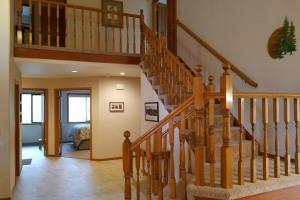 a wooden staircase in a home with a living room at 4 Approach Lane in Sunriver