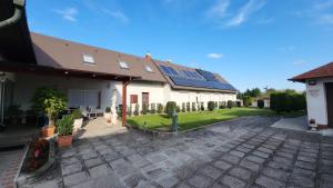 a house with solar panels on the roof at Szigetköz Győrzámoly Apartman in Győrzámoly