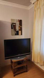 a flat screen tv sitting on a table in a living room at Szigetköz Győrzámoly Apartman in Győrzámoly