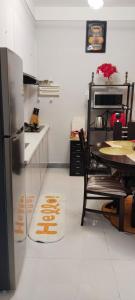 a kitchen with a table and a refrigerator at Sabaki's Homely One bedroom Apartment - Near JKIA, Airport in Marimbeti