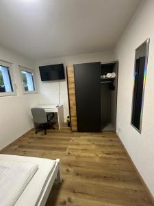 a room with a bed and a desk and a table at Gästehaus GAP in Dietlingen