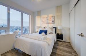 a bedroom with a large bed with a large window at Modern & Stylish Condo Downtown KW in Kitchener