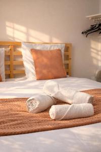 a pair of towels sitting on top of a bed at Le Royal Colbert - Hyper Centre - Cozy & Elegant in Tours