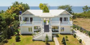 an aerial view of a house with the ocean in the background at Virmuda Villa Rental in Po-oc