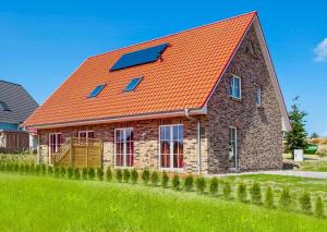 a house with an orange roof with a solar panel at Ferienhaus Mandy in Wohlenberg