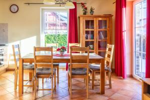 a dining room with red curtains and a table and chairs at Ferienhaus Mandy in Wohlenberg